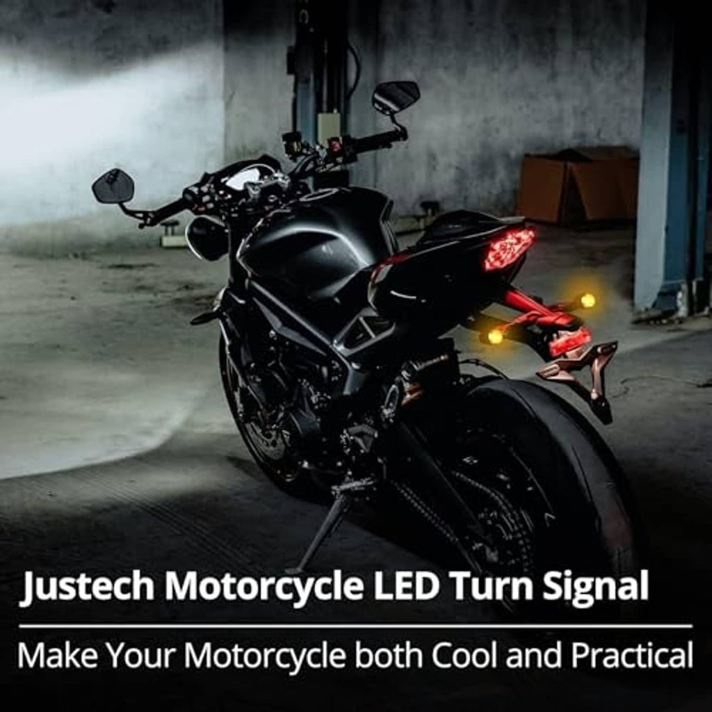 Motorcycle LED turn signals glowing amber with black bullet housings