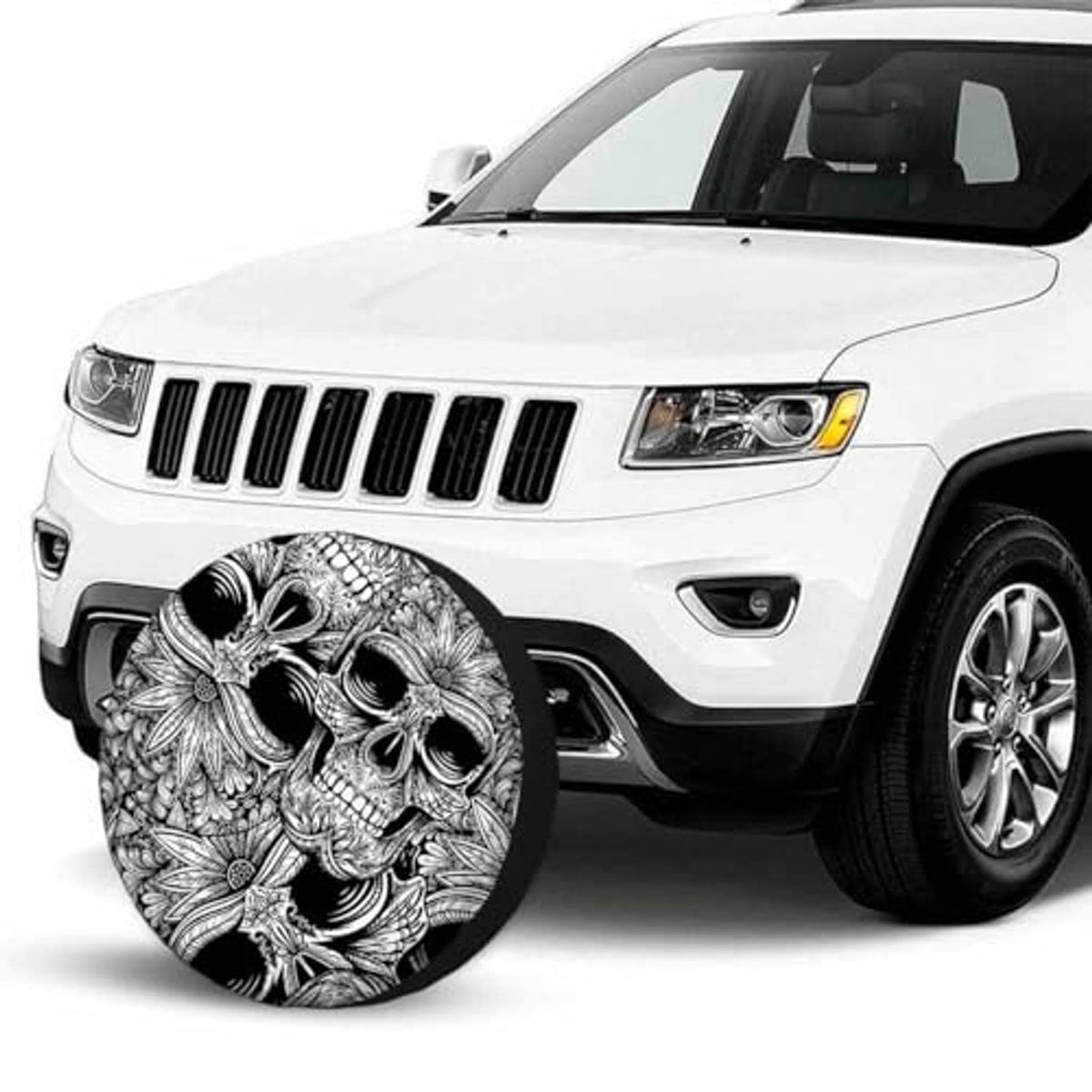 Skull wheel cover on front of white SUV, black-and-white ornate skull artwork