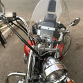 Clear detachable motorcycle windshield with black mounting bracket and hardware.