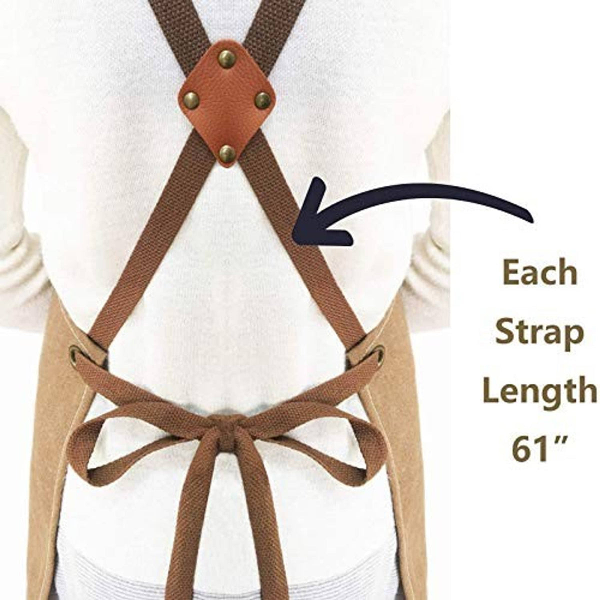 Cross-back apron tied at waist with tan leather connectors and dark strap webbing