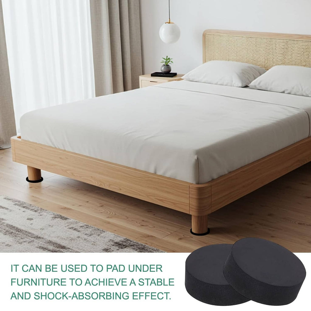 Black round non-slip furniture pads under wooden bed legs, plus spare discs