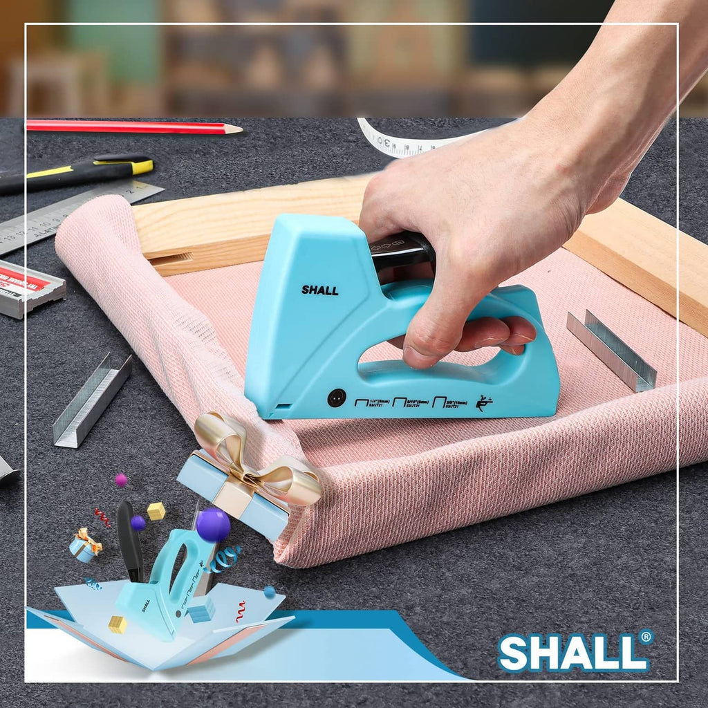 Light blue staple gun in hand fastening fabric to a wood frame