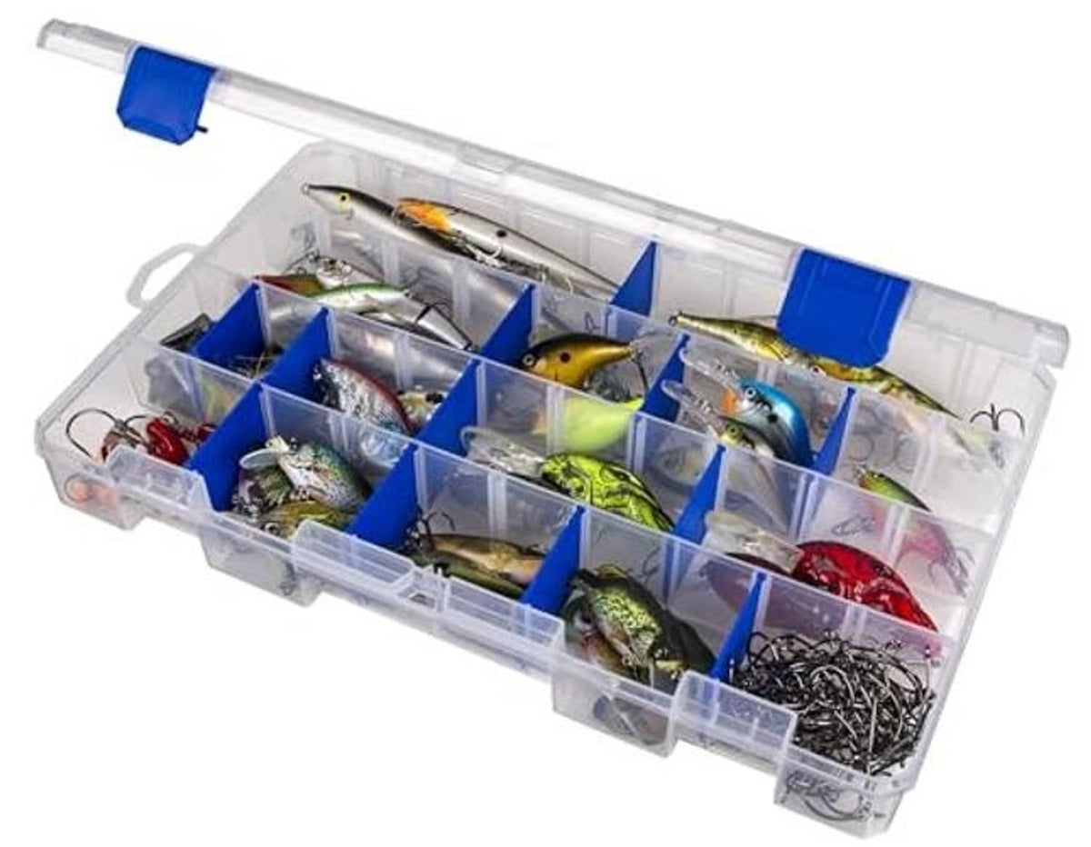 Clear tackle box with blue divider compartments and multiple fishing lures