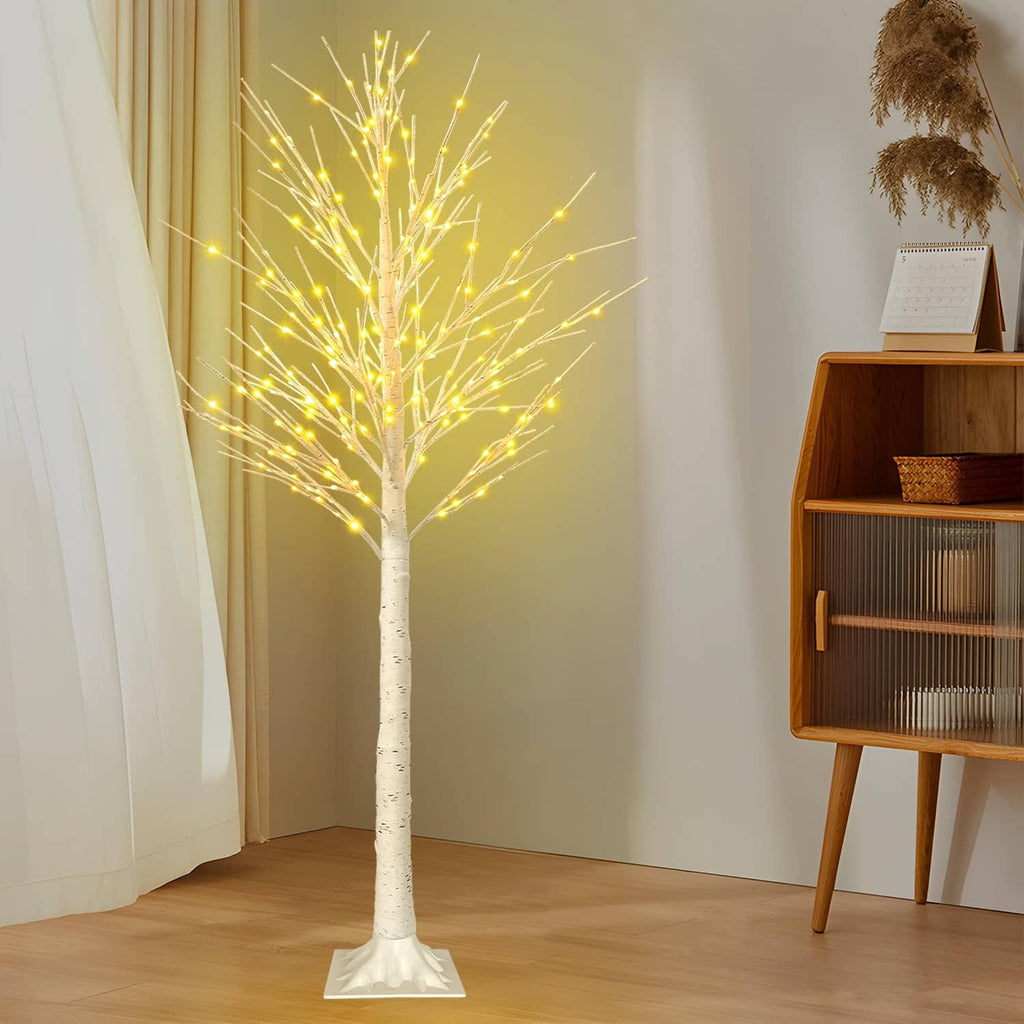 6 ft LED lighted birch tree decoration with warm white lights next to furniture