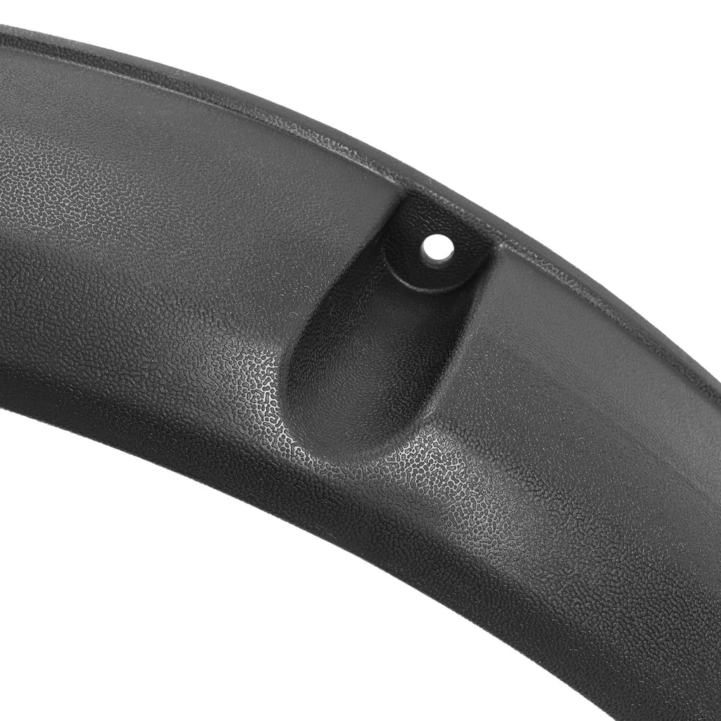 Close-up of black textured fender flare with molded inlet and round mounting hole.