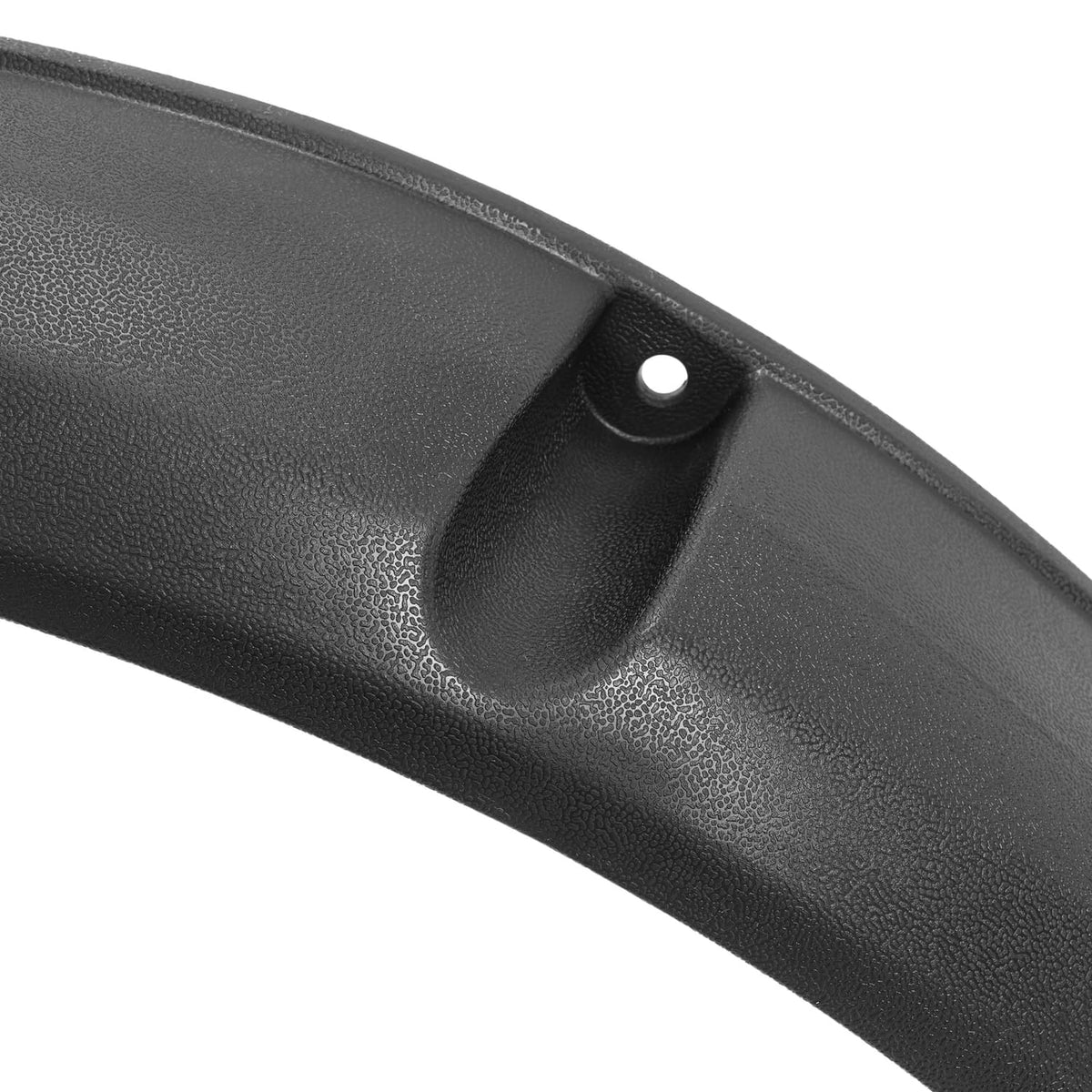 Close-up of black textured fender flare with molded inlet and round mounting hole.