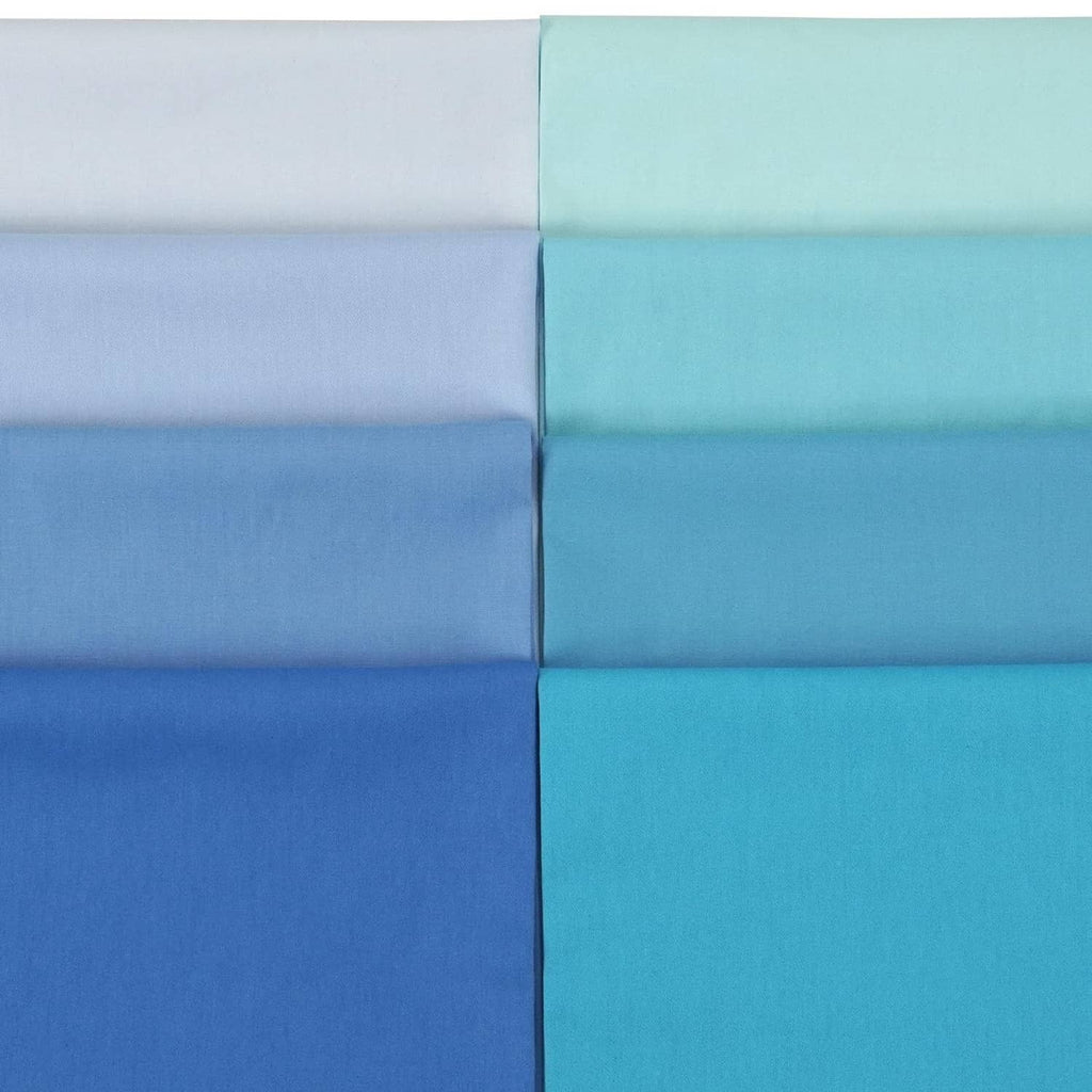 Folded solid cotton fabric pieces in light blue, aqua, and white panels