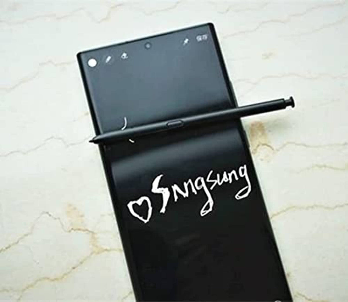 Black Bluetooth S Pen stylus resting on phone edge, angled with tip visible