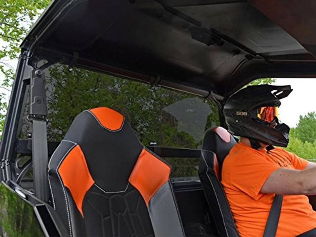 Dark-tinted rear windshield from inside the cab with black and orange seats visible