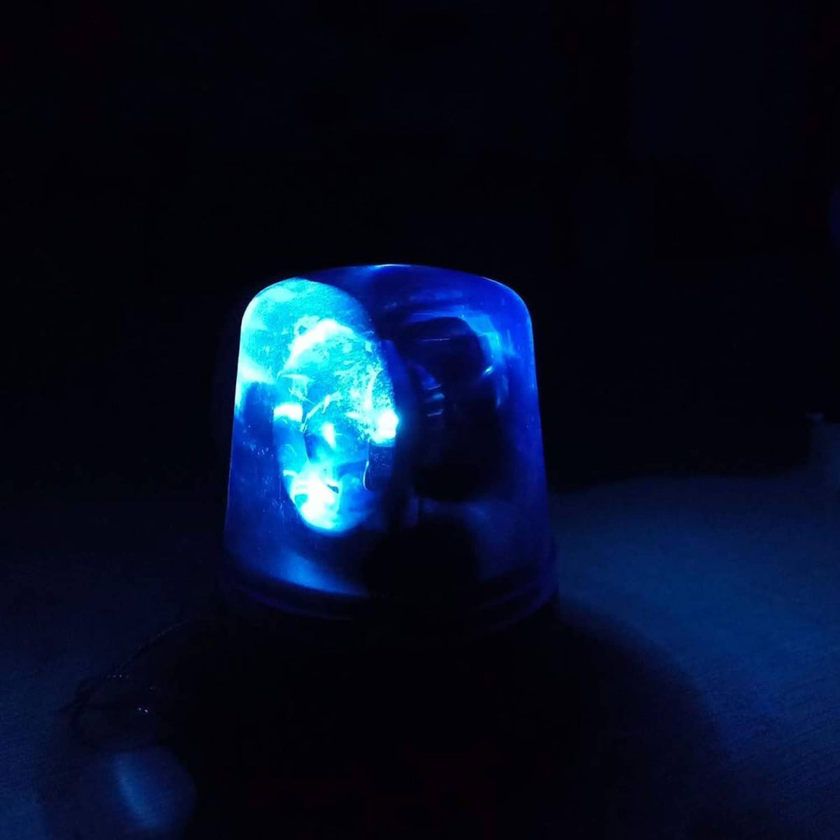 Blue LED strobe disco light glowing dome with bright rotating beam effect