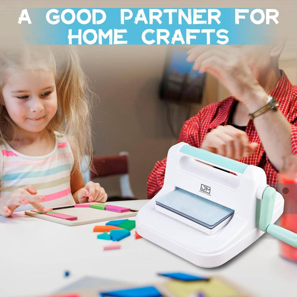Manual die cutting and embossing machine on tabletop with hands arranging craft paper