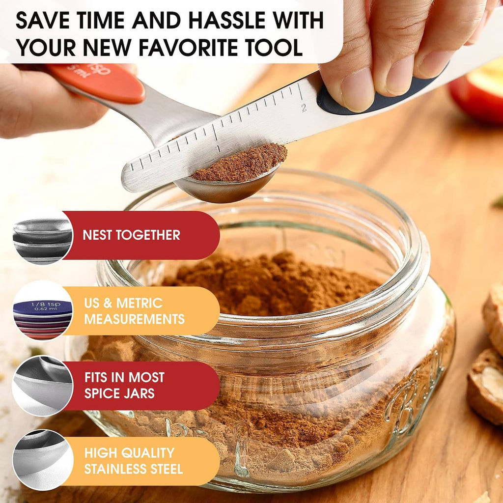 Nested stainless steel magnetic measuring spoons above a glass jar of spices