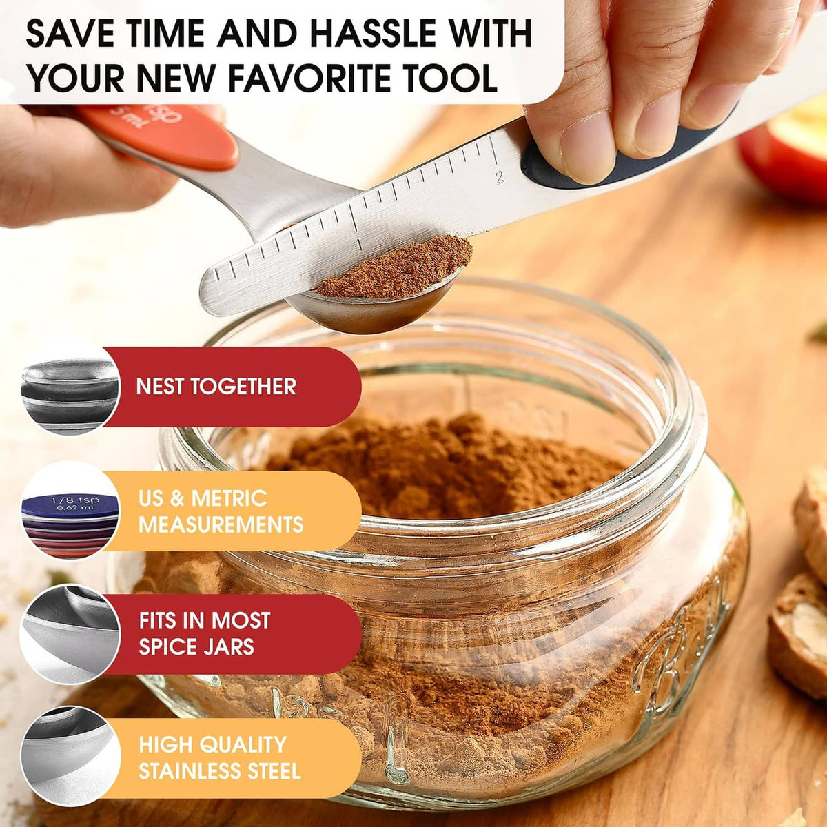 Nested stainless steel magnetic measuring spoons above a glass jar of spices