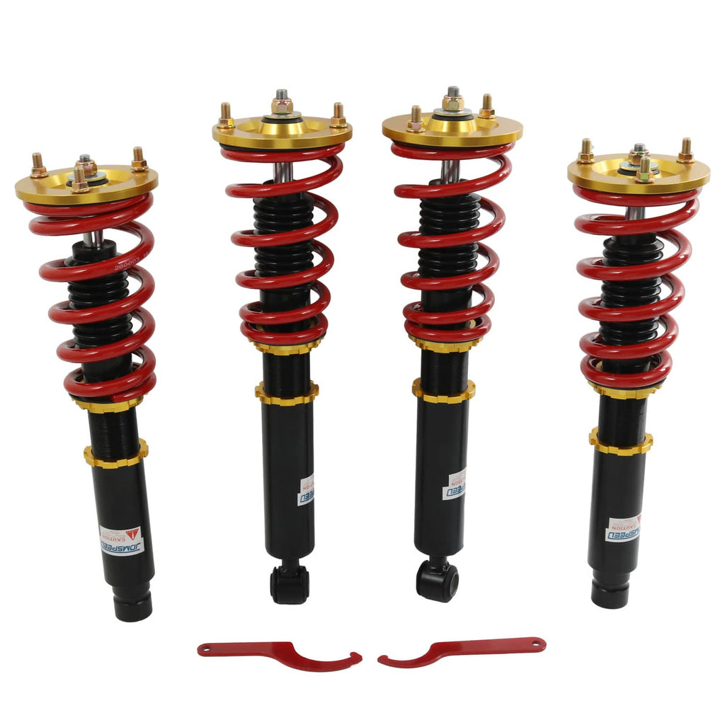 Coilover shock suspension kit with four black dampers, red springs, and red bracket pieces