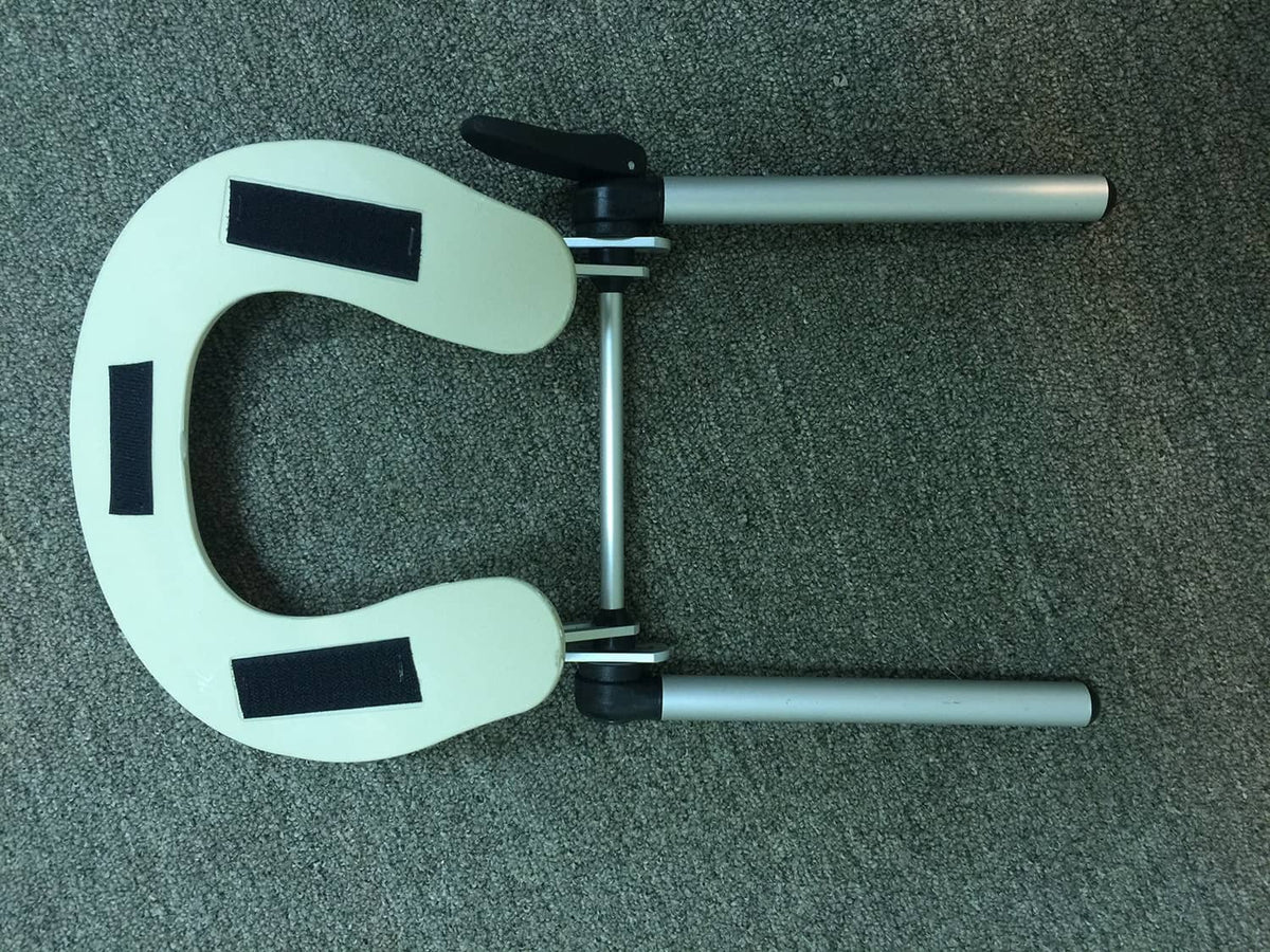 Adjustable face support with C-shaped pale plate, black straps, and two silver metal bars