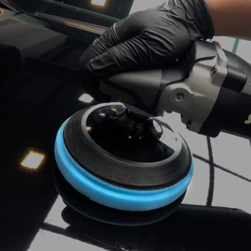 Blue foam polishing pad mounted on a power buffer