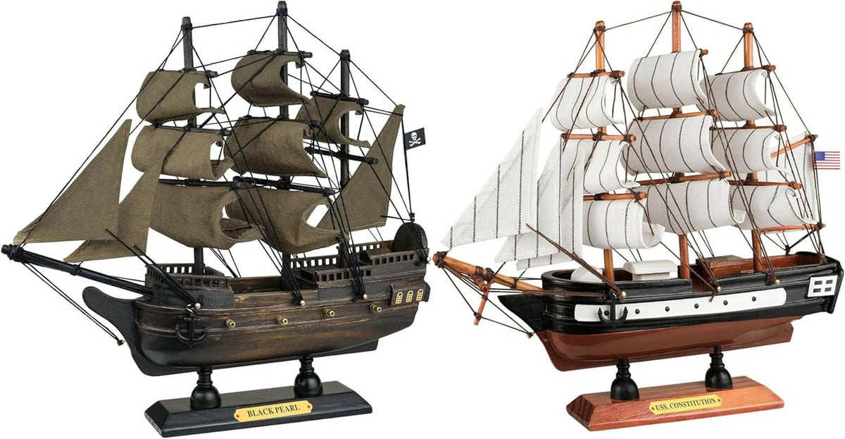 Two wooden sailing ship models with dark and white hulls on display bases