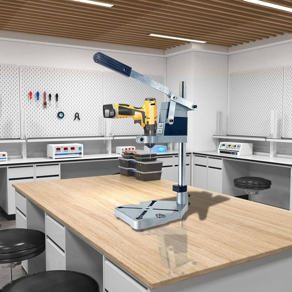 Bench-mounted drill press stand with blue lever and gray base on a wooden worktable