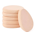 Stack of beige flat makeup sponges with smooth teardrop surfaces
