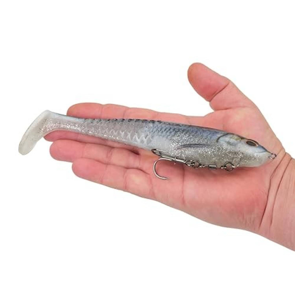 Soft plastic swimbait in hand, silver-blue glitter body with treble hooks