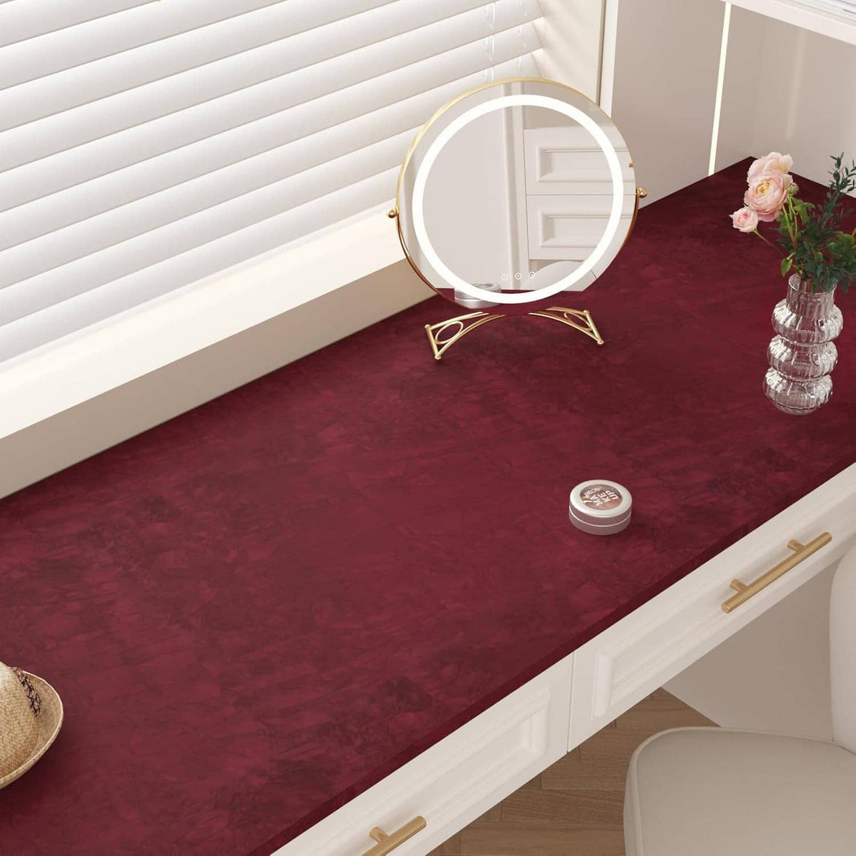 Dark red velvet flocking liner sheet on a vanity shelf surface