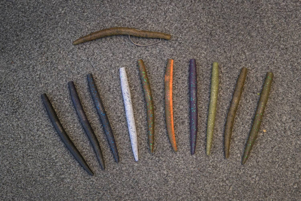Assorted dark stick worms with blue flecks and tapered ribbed bodies