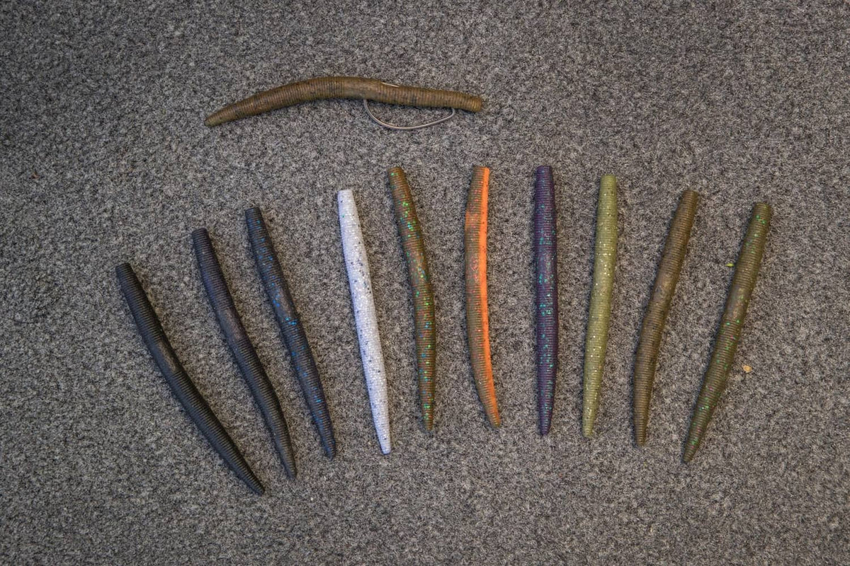 Assorted dark stick worms with blue flecks and tapered ribbed bodies