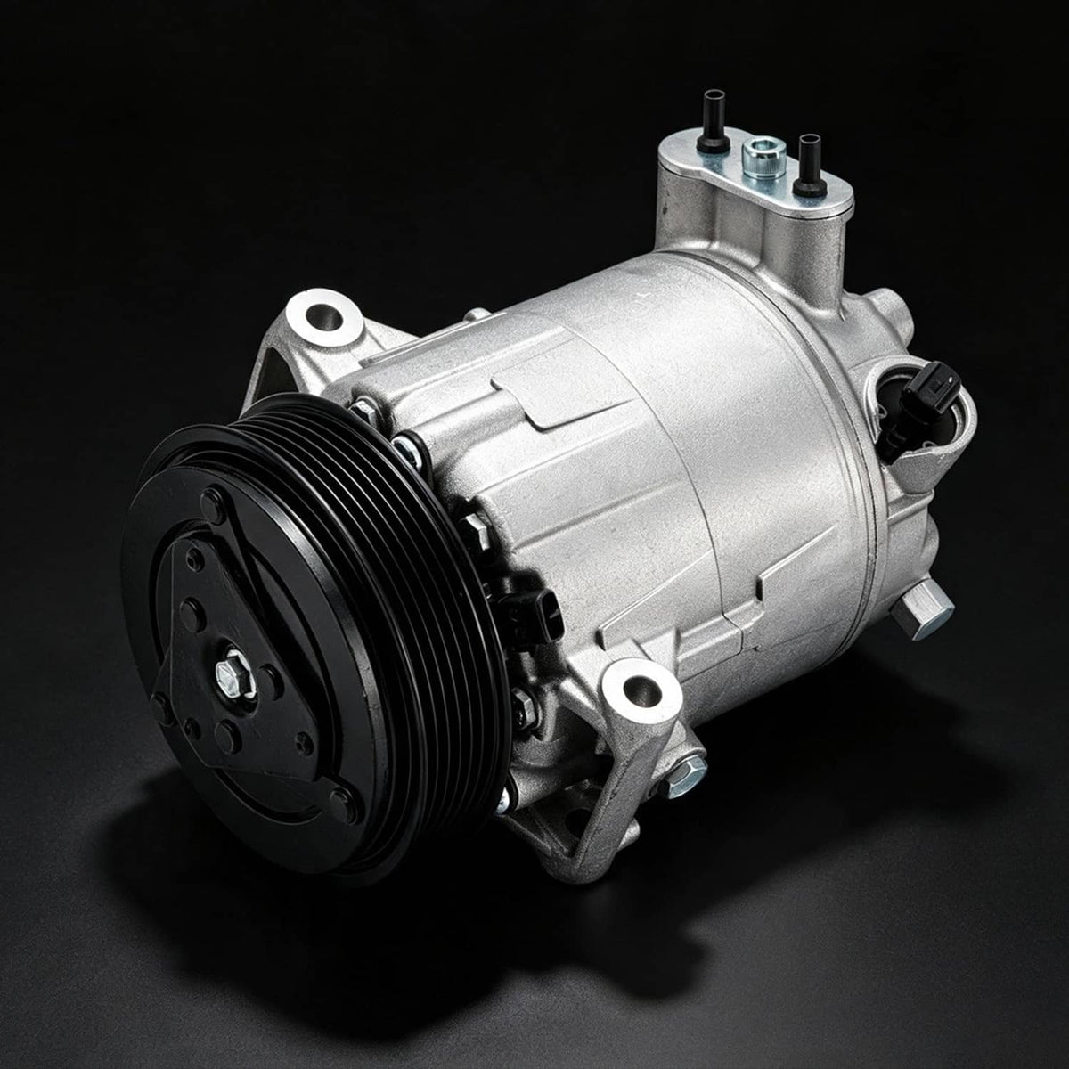 A/C compressor with clutch, angled view of silver body and black pulley