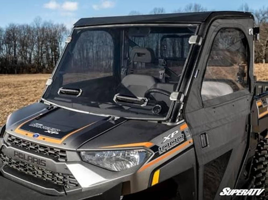 Close-up of dark-tinted full windshield with cab frame and front mounting brackets