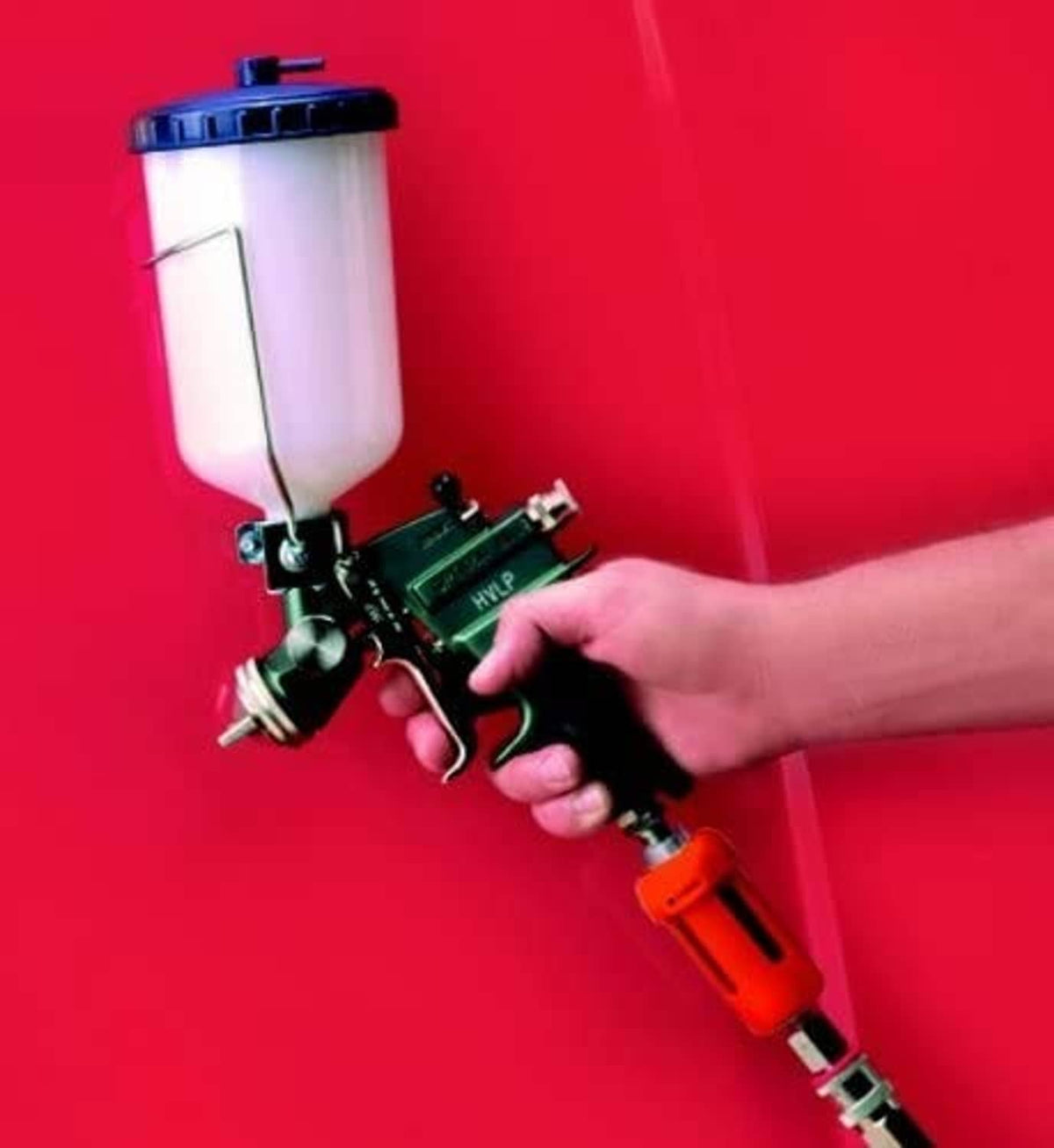 Pneumatic spray gun with orange desiccant filter cartridge attached