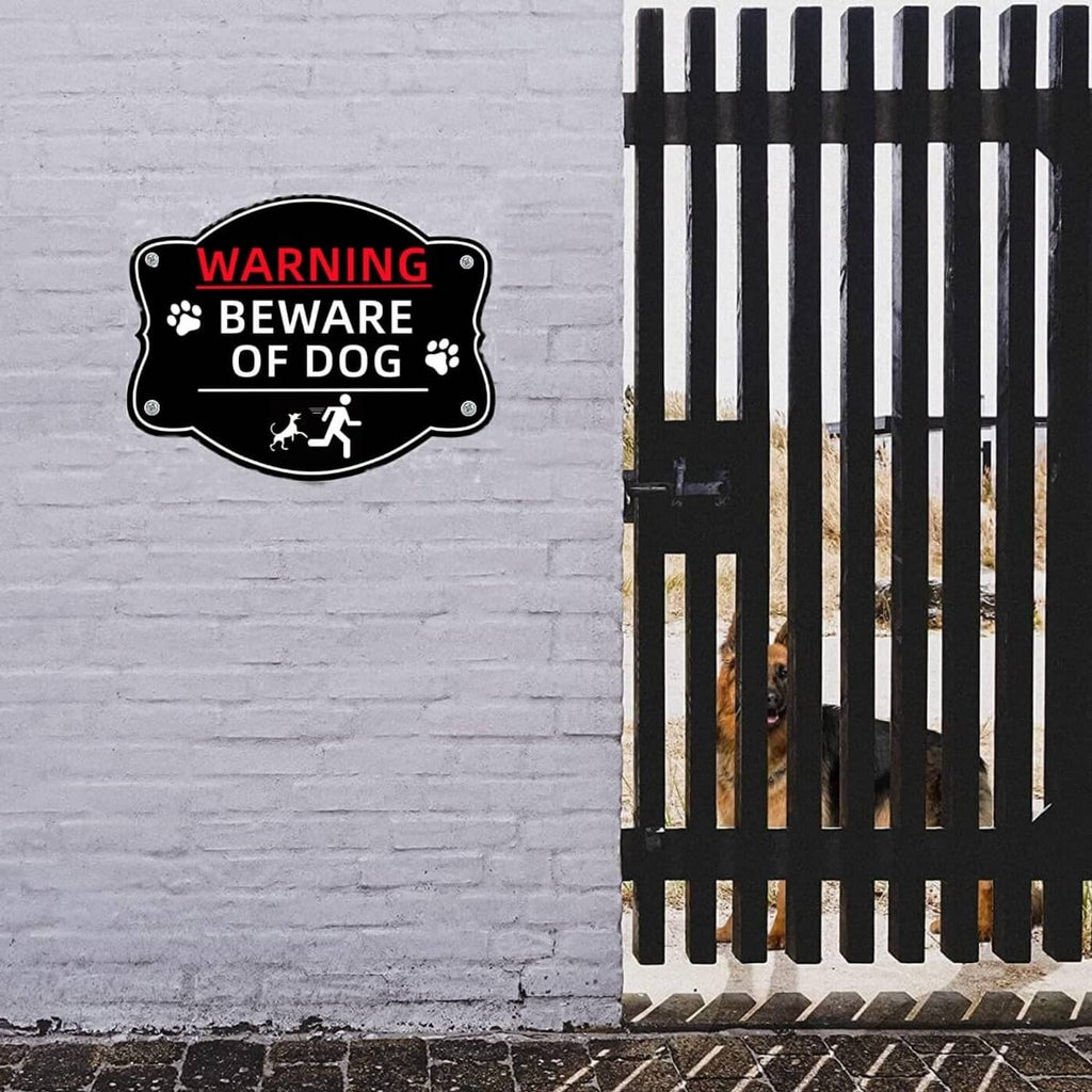Small black “WARNING BEWARE OF DOG” sign on a fence with paw print icons