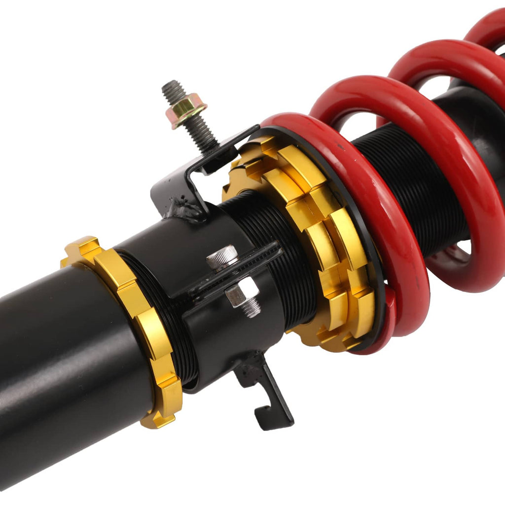 Coilover shock absorber showing threaded adjuster rings and red coil spring