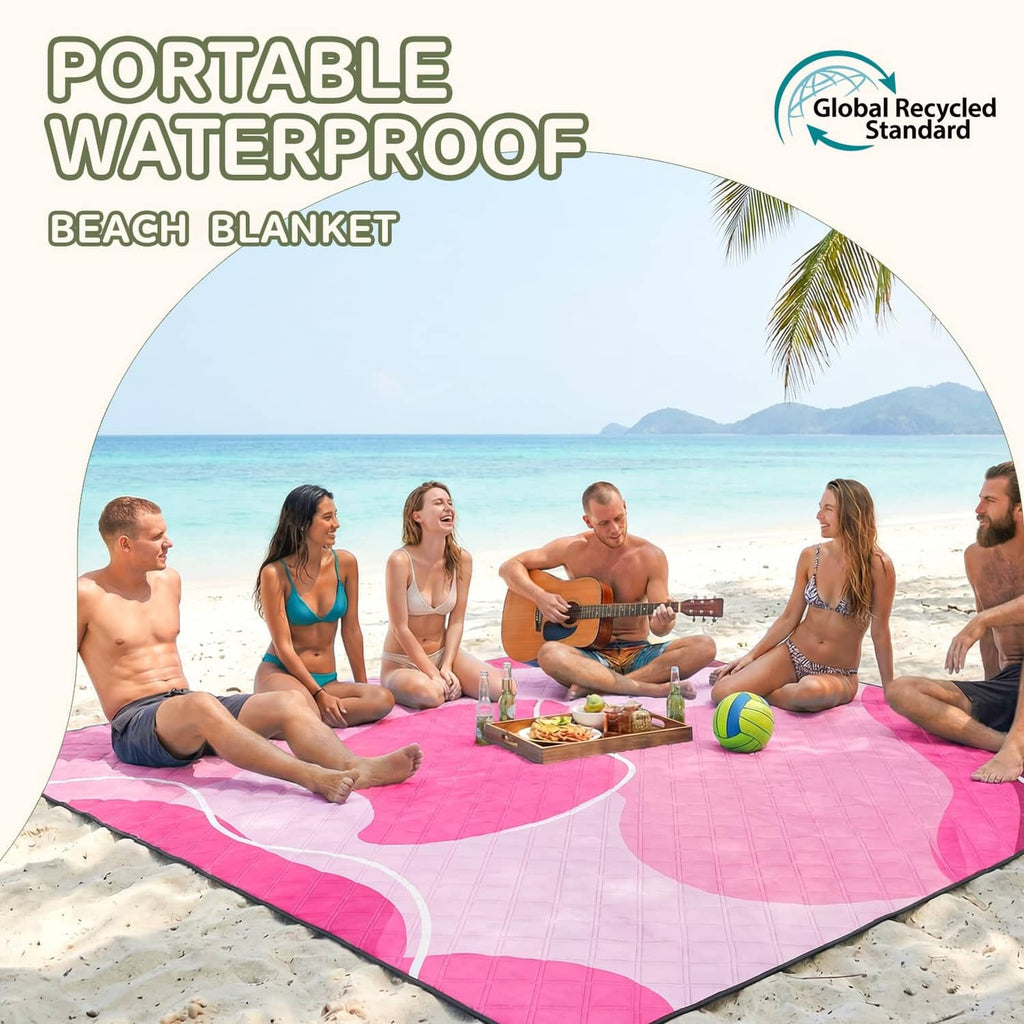 Pink waterproof beach picnic blanket spread on sand with rounded edges