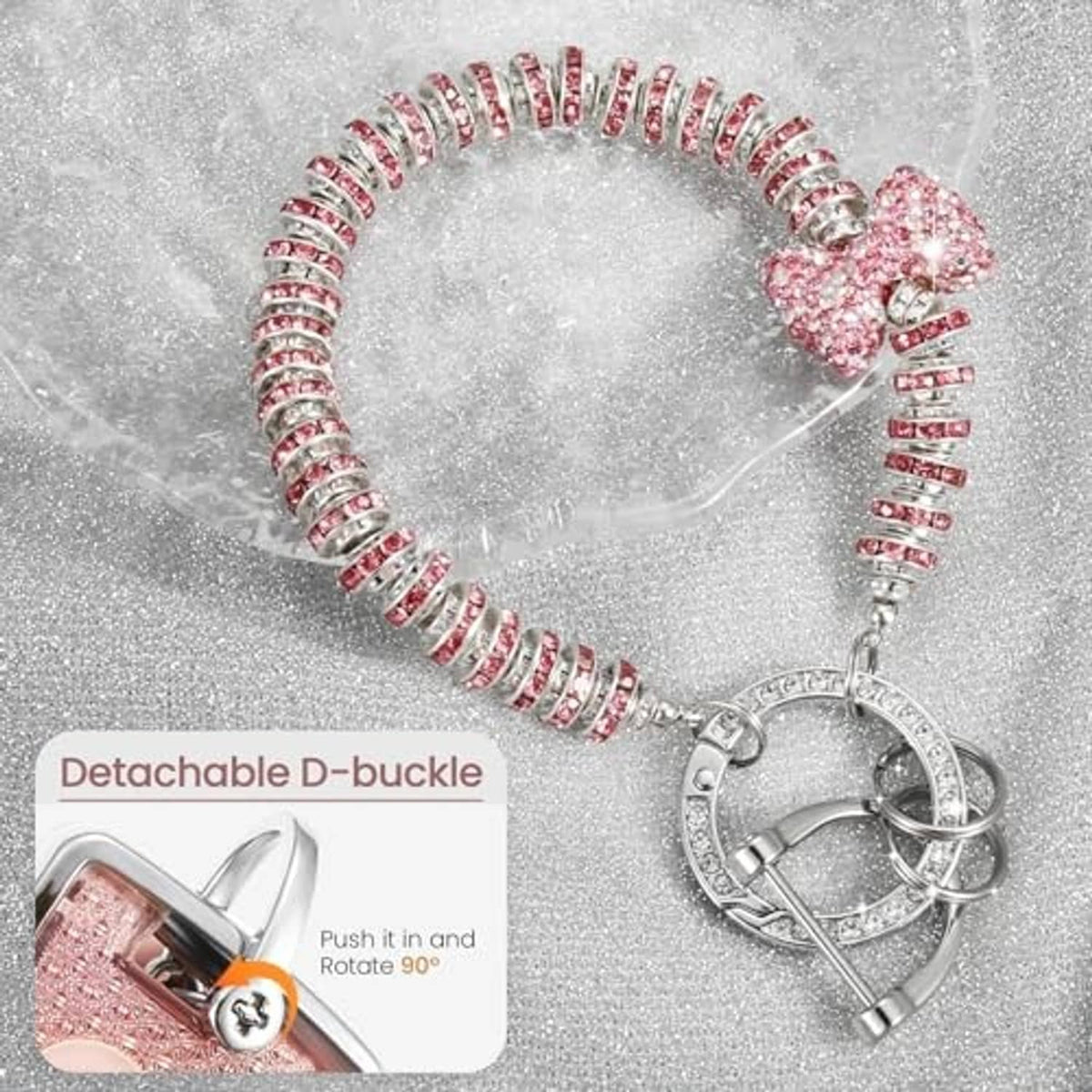 Pink glitter wristlet with rhinestone chain, bow charm, D-buckle and key ring