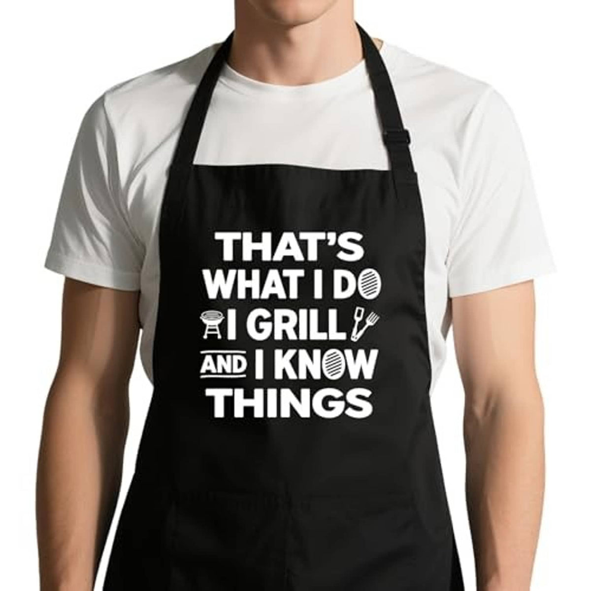 Black grilling apron with white "THAT'S WHAT I DO" text and adjustable neck strap
