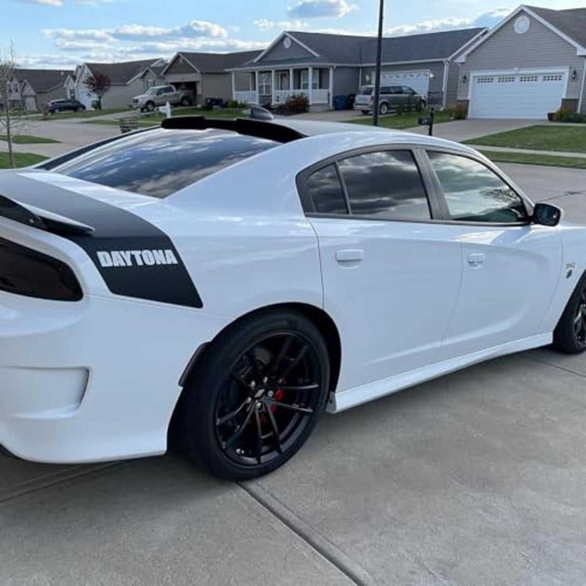 Rear window roof spoiler visor wing on white car roof, gloss black