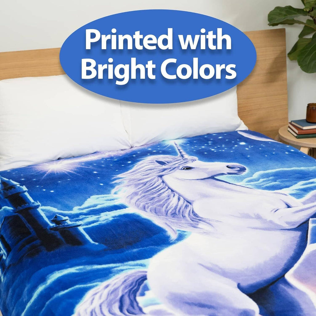 Blue unicorn fleece blanket spread on a bed with starry night illustration