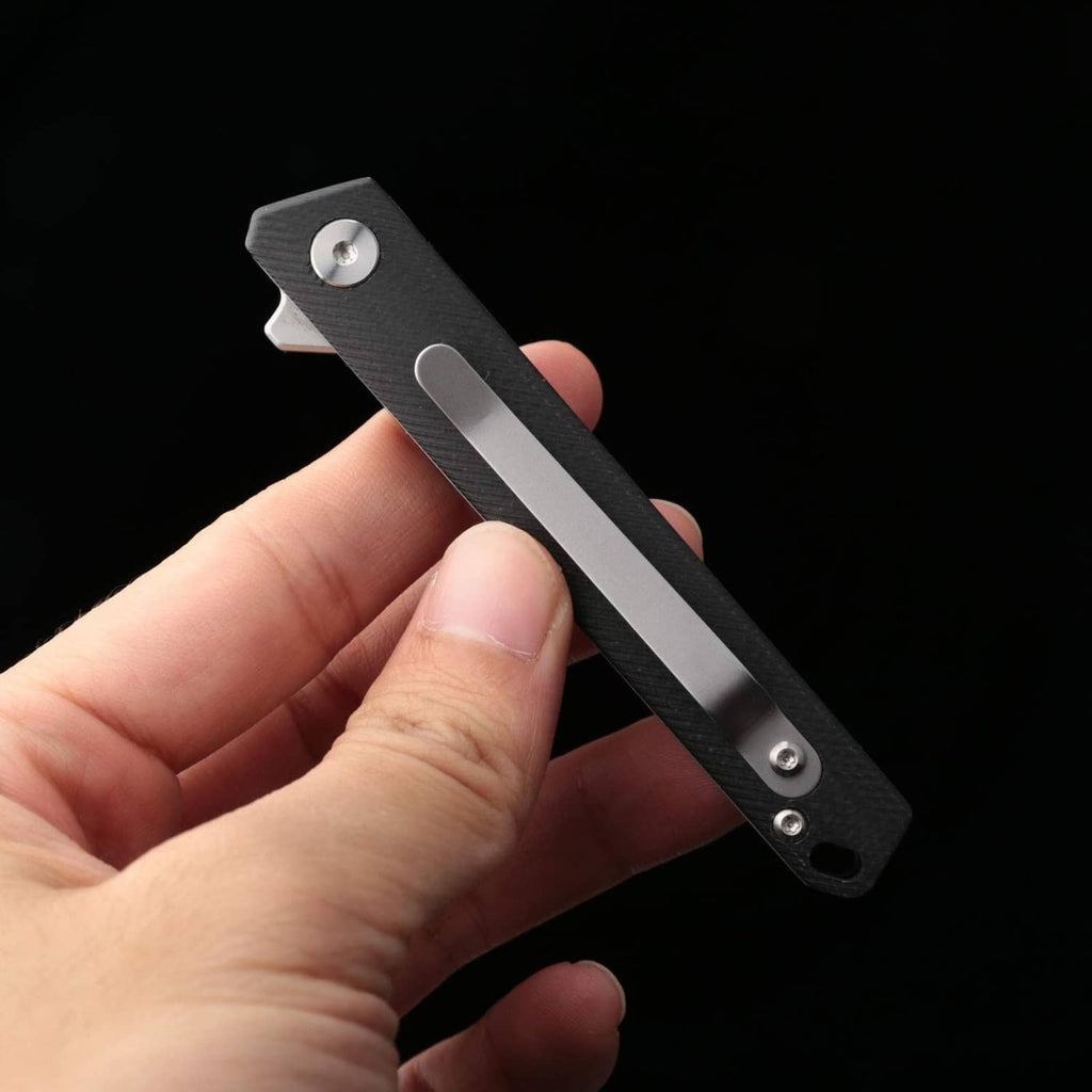 Compact flipper folding pocket knife with black handle and silver blade visible