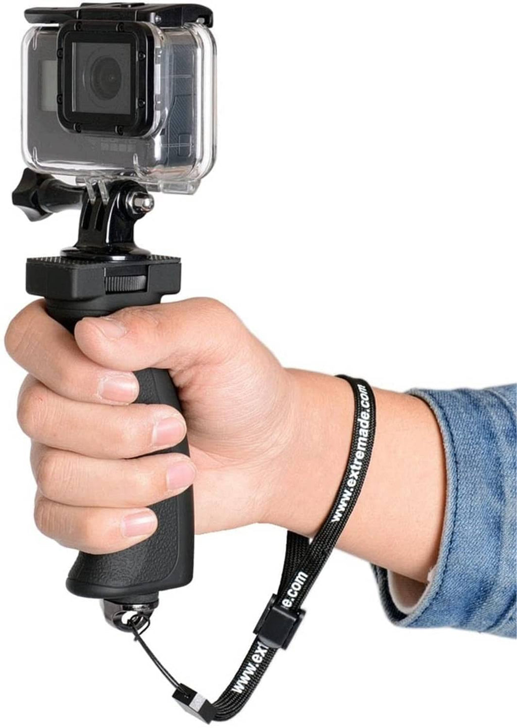 Black camera grip held in hand with wrist strap attached