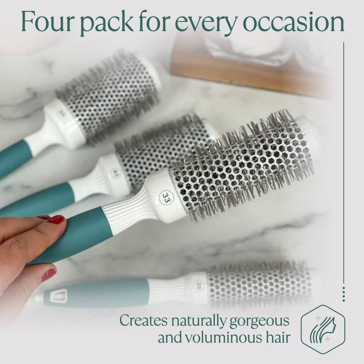 Four-pack round blow-dry brushes with silver bristles, white handles, teal accents