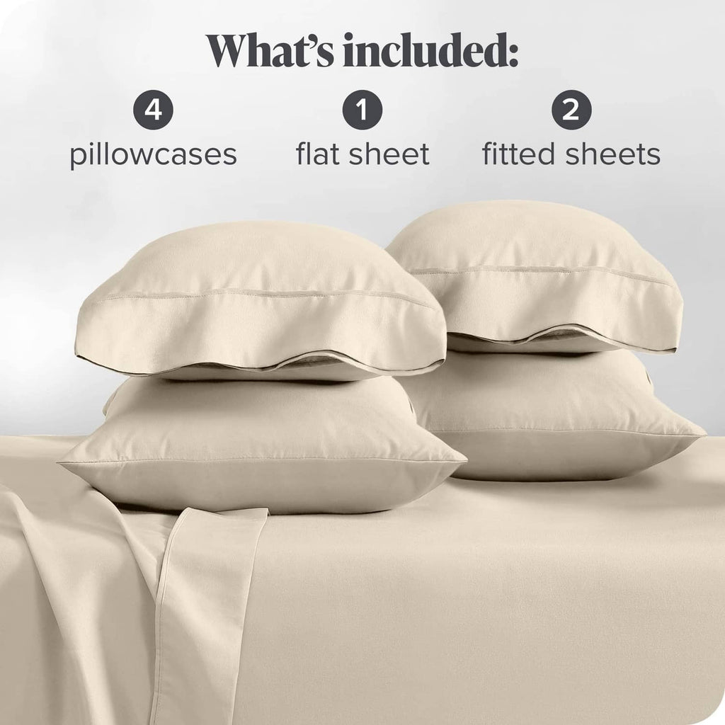 Cream pillowcases and folded sheet set pieces, neatly arranged for split king bed