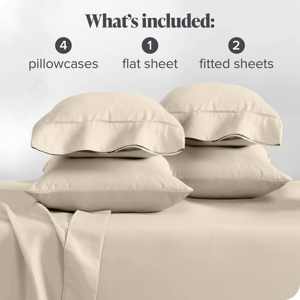 Cream pillowcases and folded sheet set pieces, neatly arranged for split king bed