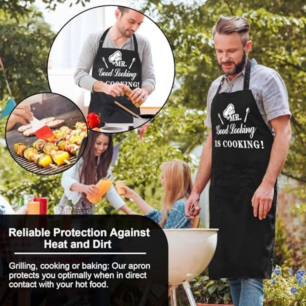 Black cooking apron with front pocket and “MR. Good Looking IS COOKING!” text