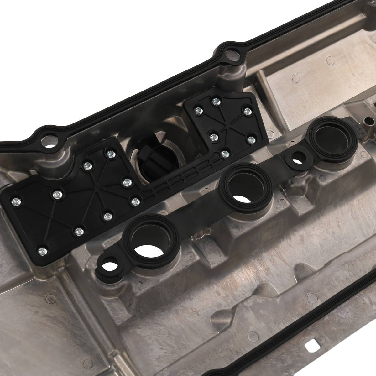 Valve cover gasket set area with round seals and black mounting bracket, close-up
