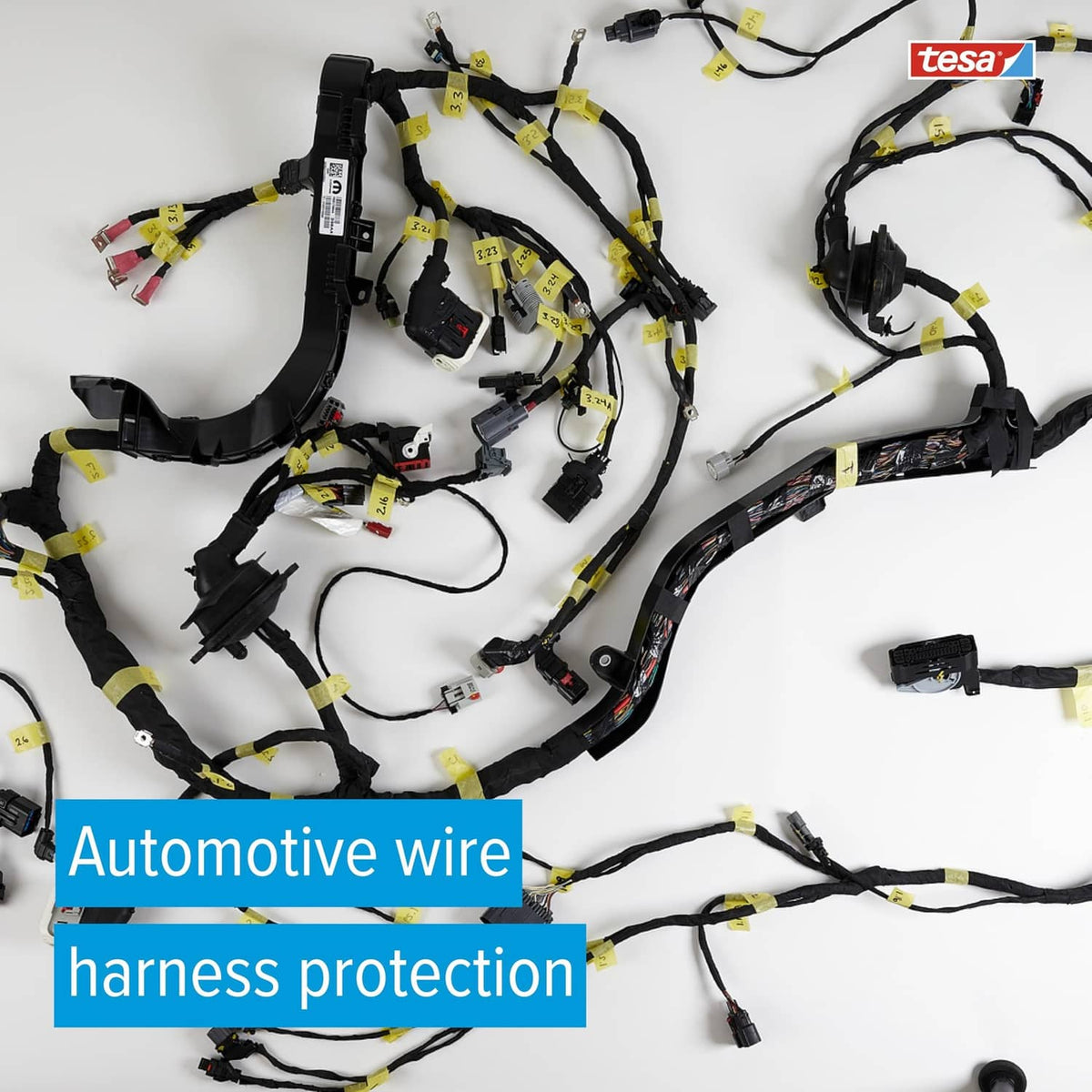 Black tesa noise-damping tape wrapped around an automotive wire harness bundle