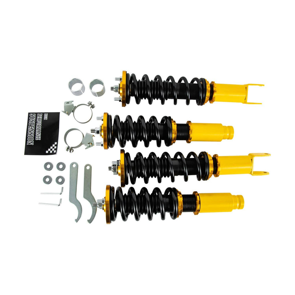 Set of adjustable coilover shocks with black coil springs and yellow dampers, with accessories
