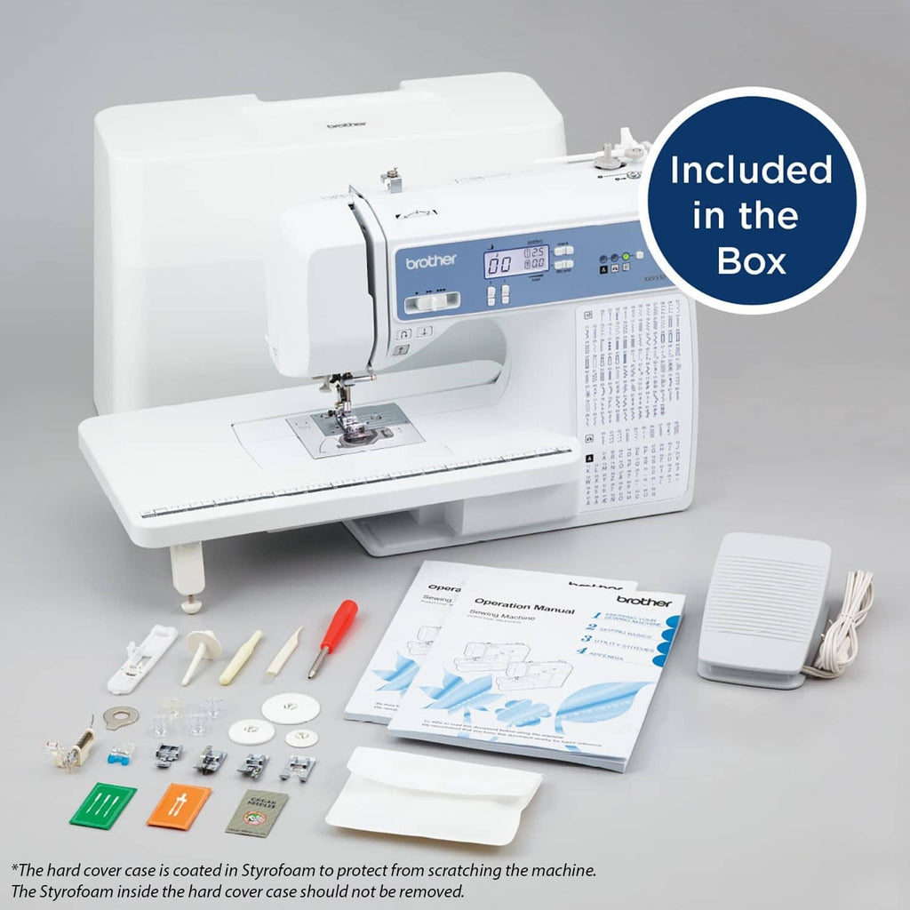 White computerized sewing machine with accessory kit items laid out beside it.