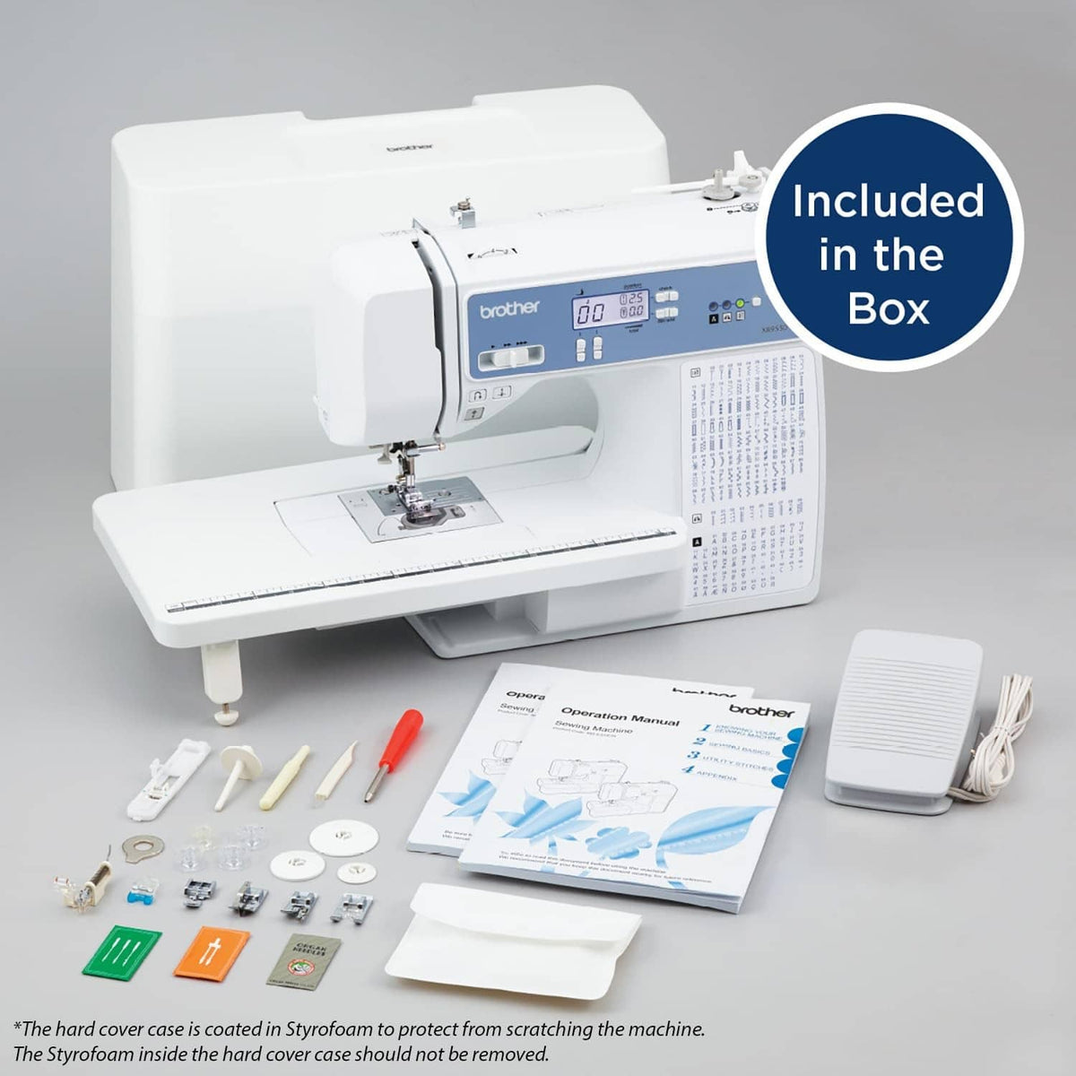 White computerized sewing machine with accessory kit items laid out beside it.