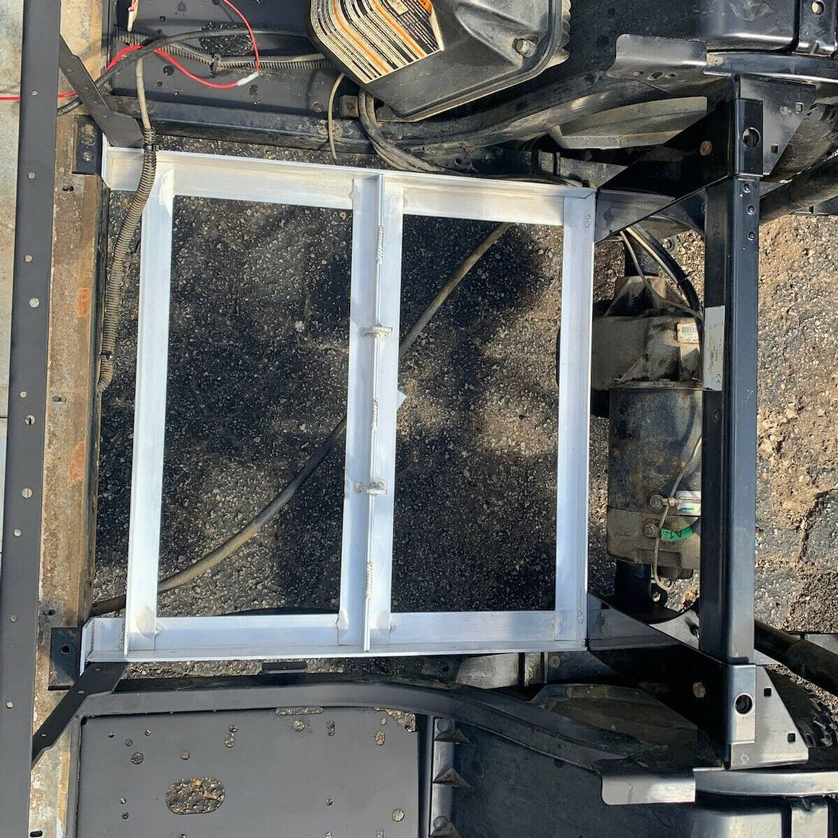 Aluminum battery tray installed with side supports and wiring clearance