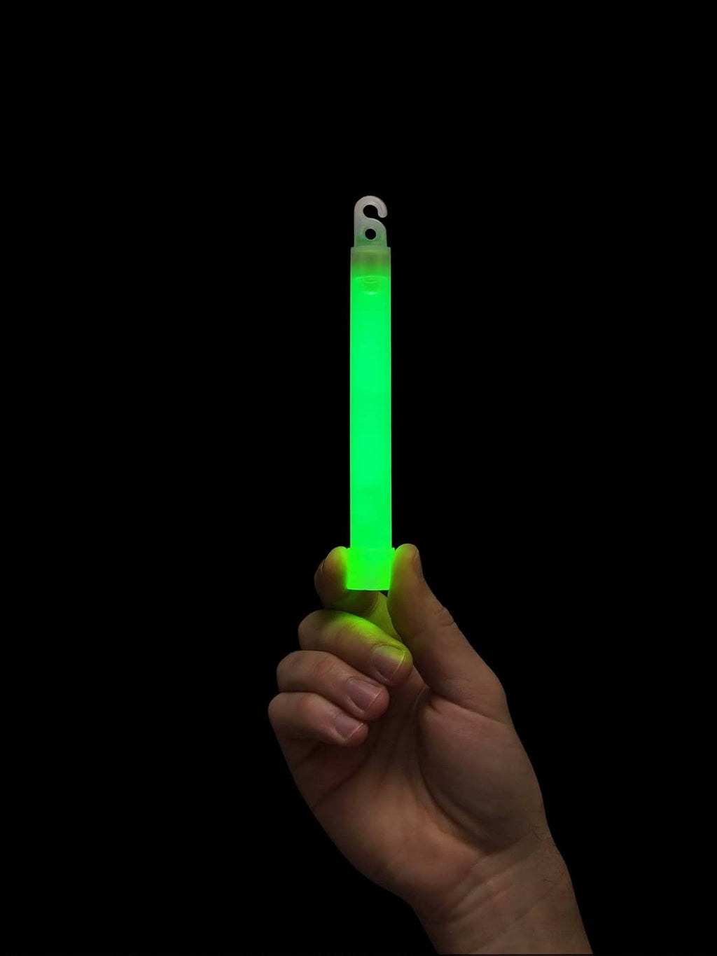 Hand holding a glowing green safety glow stick with loop hook